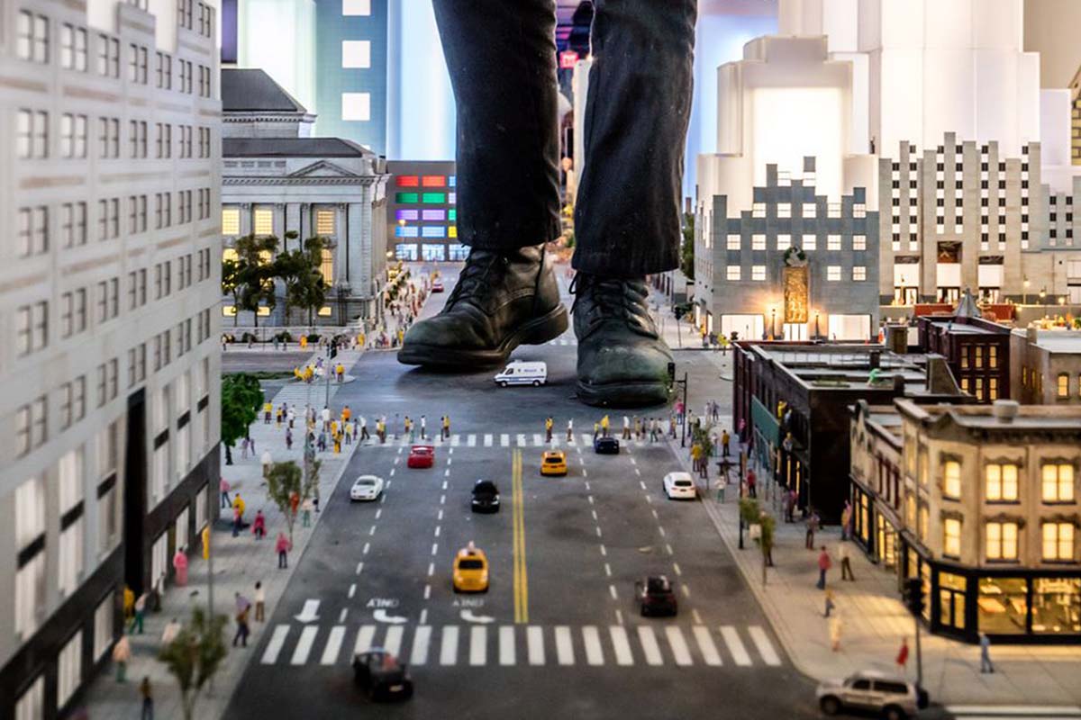 Boots standing on miniature New York street scene.